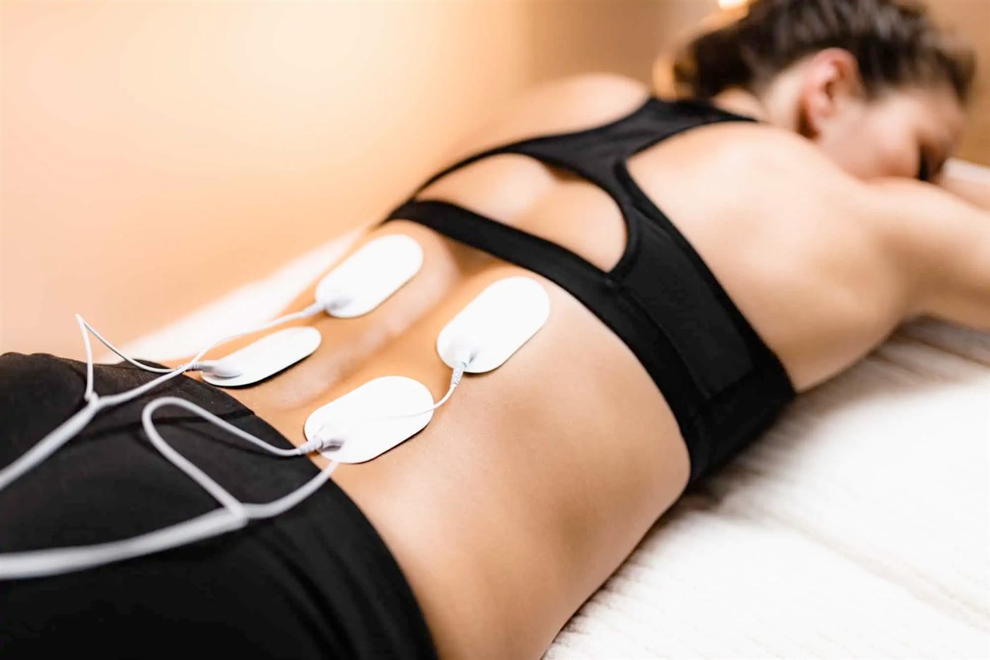 Electrical stimulation pads on the lower back